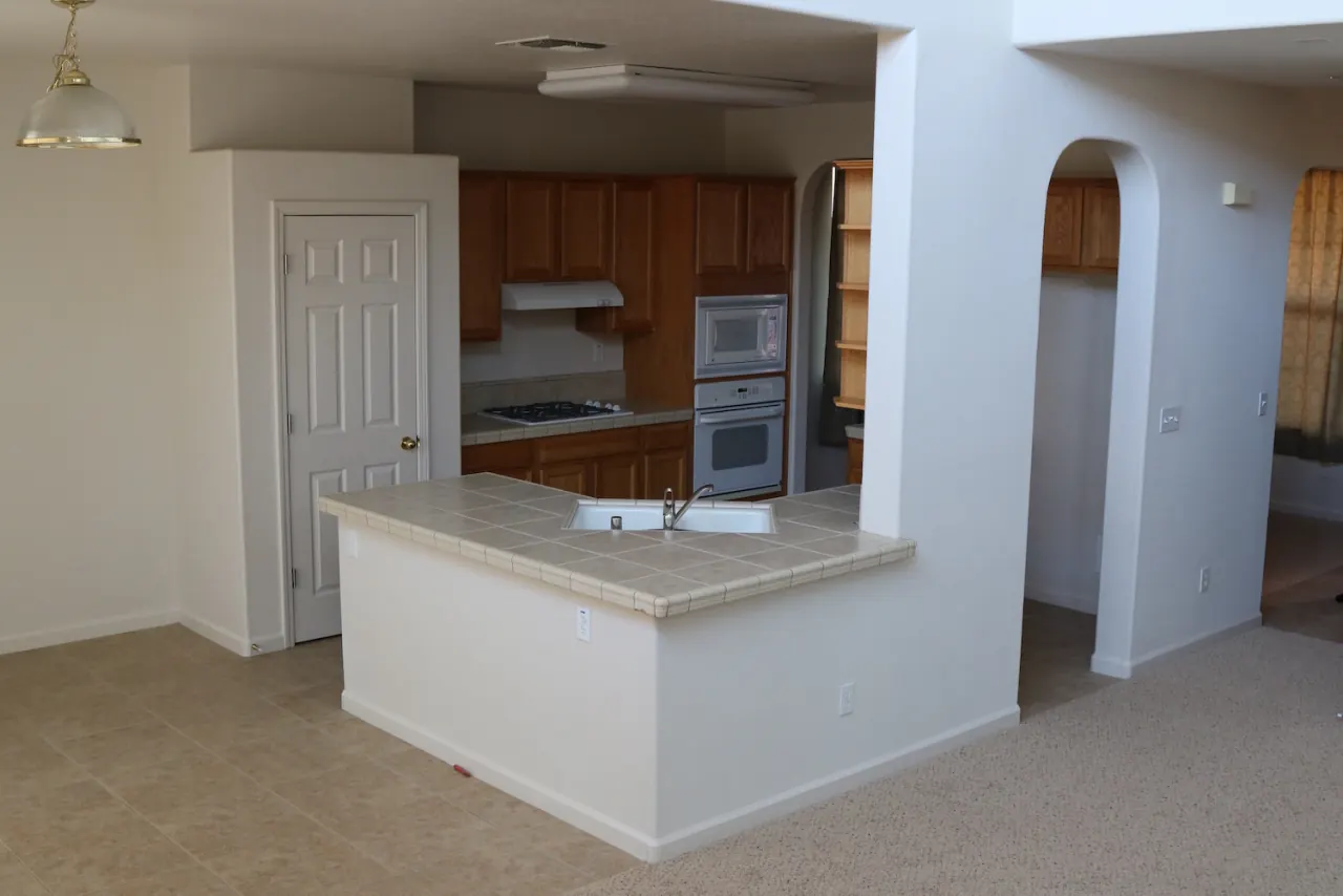 Shared kitchen with a breakfast counter and built-in appliances